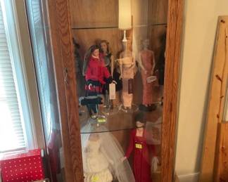 Oak lighted display cabinet displaying Robert Tonner dolls