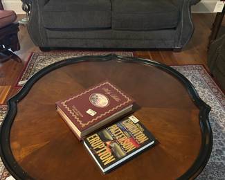 books, coffee table, loveseat, pillows, rug