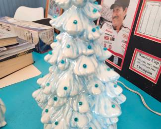 12 in tall ceramic Christmas tree with a surprise in the back. $40, sold as is I think it needs a rubber gasket to keep the tree on top from moving