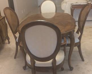 White furniture Co Vintage dining room table. Missing extension leaf, but you could make one and put a table cloth over when you need to extend it. 6 fabric chairs - 2 with arms, 4 with cane back. White fabric.