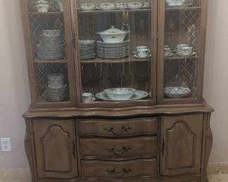 Vintage china cabinet with with gold trim on side glass sections.