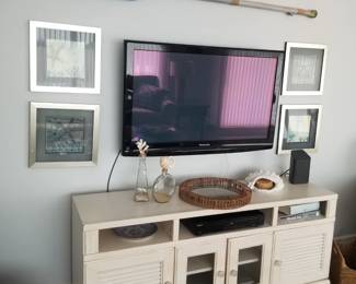 Entertainment console; decorative oar; framed artwork