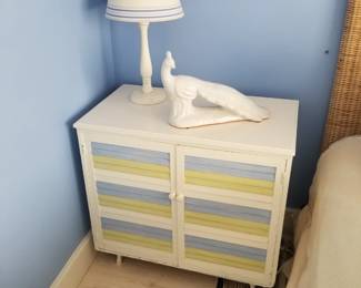 Painted cupboard; table lamp; peacock sculpture