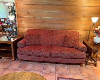 full view of sofa and end table with the brass lamps
