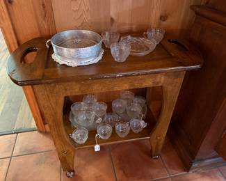 Hand crafted rolling tea cart with glass dessert plates and cups, aluminum cassarole holder