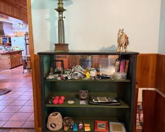 Shelf  with whatnots and brass lamp