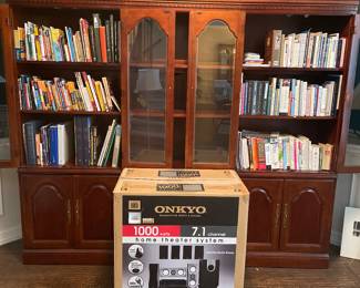 Bookcases filled with interesting books, and NEW in box ONKYO home theater system.