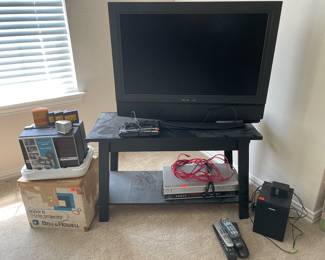 Several TVs at this home, and a Bell & Howell Super 8 Movie Projector 