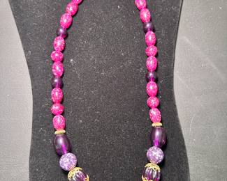 Beautiful shades of purple and pink with gold necklace