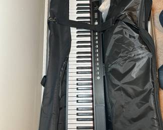 88-key portable digital piano keyboard in a carrying case
