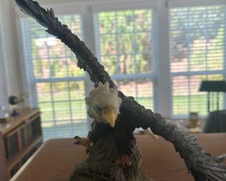  collectible figurine of a bald eagle landing on a rock 