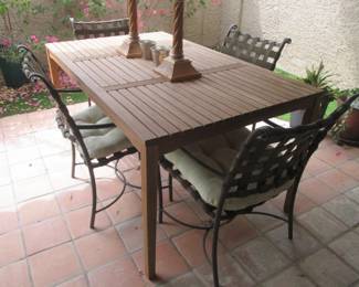 Teak Patio Table By "Outdoor Interiors",                                   38" X 84" X 30" High.                                                                                        4-Vintage Metal Arm Chairs With Cushions                    (Could be Brown Jordan?)