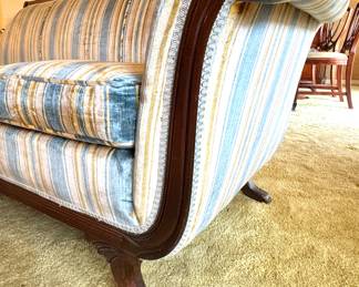 Vintage Sofa Detail – Rolled Arm, Carved Wood Feet, and Blue-Gold Striped Upholstery