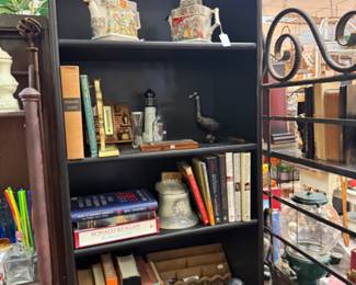 Vintage books, black wooden bookshelf, many decorative objects