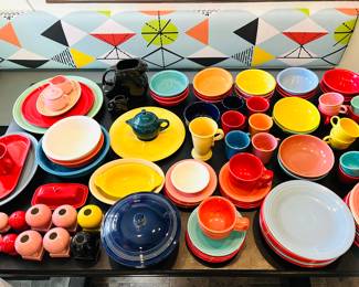 Large variety of Fiestaware plates, mugs, salt and pepper shakers, pitchers, and other dishes. 