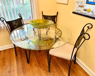 Round glass and iron table and chairs.