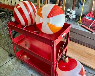 Red metal rolling cart and large vintage Christmas balls.