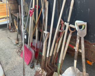 Loads of shovels, rakes,  landscaping tools, barrels