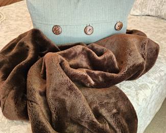 Cozy Faux Fur Throw Paired with an Aqua Colored Throw Pillow with Large Button Accents