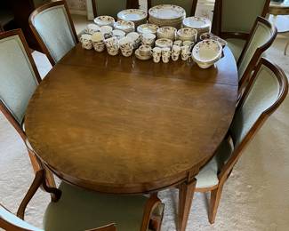 Baker Furniture dining table with eight chairs, three leaves and pads.