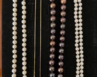 Left to right: Ladies 18-inch uniform knotted strand of 7-7-1/2mm mostly round yellow/cream-cultured pearls clasped in filigree 14K gold; 14K gold chain; Ladies 18-inch knotted uniform strand of 11.0mm chocolate freshwater cultured pearls clasped in 14K rose gold (clasp accented w/.01tdw mined accent diamonds); Ladies 24-inch uniform knotted strand of 6-1/2mm round white light-rose cultured pearls clasped in ribbed 14K gold.