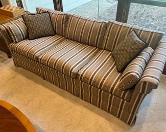 One of two matching upholstered couches in very good condition.