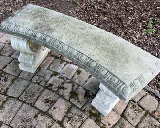 Cement curved outdoor bench.