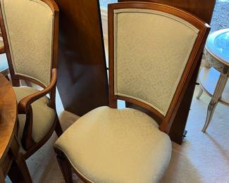 Closer view of one of the eight chairs and two of the three leaves to be sold with the Baker Furniture dining table.