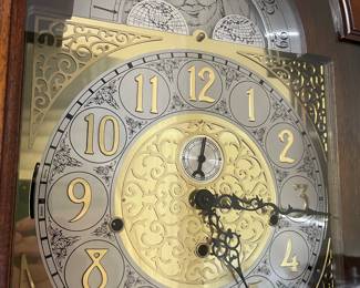 Close-up view of the face of the Colonial grandfather clock.