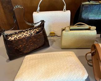 Large selection of designer handbags and purses.