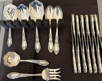 Closer view of large set of Towle sterling flatware, including many serving pieces.