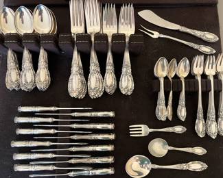 Closer view of large set of Towle sterling flatware, including many serving pieces.