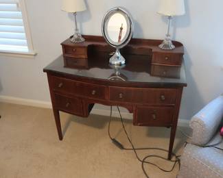 another view  of  desk  There  are  also  two lamps  and  mirror.