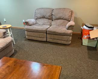 Coffee table and couch and love seat recliners 
O


