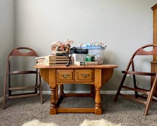 Drop leaf table; can be used at a coffee table or side table.  Wooden folding chairs