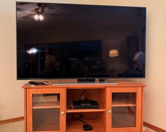 Samsung UN65HU855F 65" Smart TV, AppleTV with Siri Remote, DVD player and a wooden entertainment console that will probably hold all the other gadgets that you want to hook up to this amazing screen.