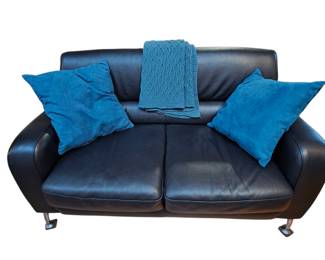Lot #113 - Natuzzi Italian Contemporary Leather Loveseat With Blanket and Throw Pillows