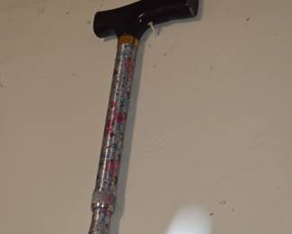 Metal cane with wood handle. Stretch to breaks down. 