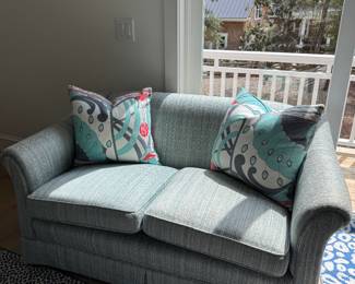 light blue loveseat and pillows