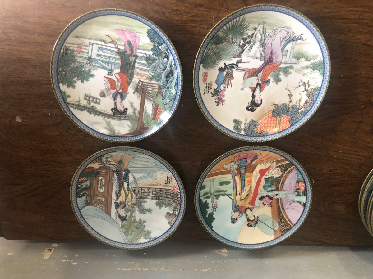 Set of hand-painted porcelain plates with traditional Chinese scenes