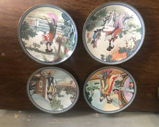 Set of hand-painted porcelain plates with traditional Chinese scenes