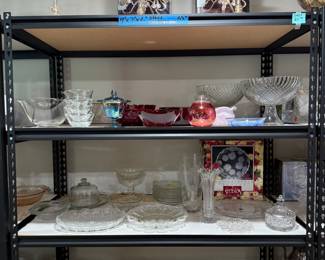 Three silver-plated candelabras, two matching – plus one brass candelabra. Various cranberry glass items, various crystal and glass items.