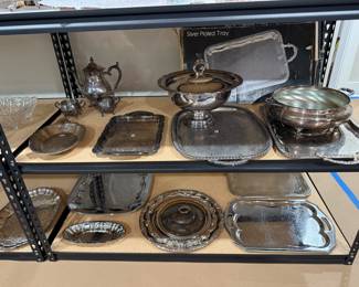 Various silver-plated serving items.