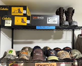 Various pairs of boots. Various new ball caps.