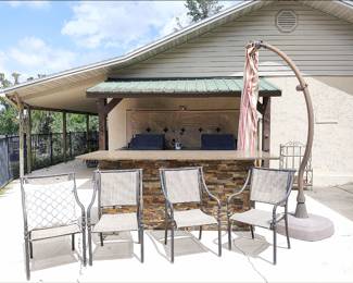 Outdoor Kitchen with Chairs, Pedestal Umbrella, Bar with Large Granite Top, Two Infared Grills.