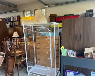 Dining room tables and chairs, desk and multiple clothes dressers.  Lamps
