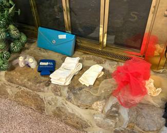 Small blue clutch, & miscellaneous on fireplace in living room 