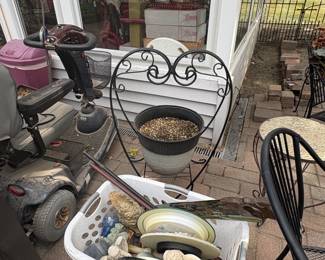 . . . wrought-iron heart and baskets full of yard art
