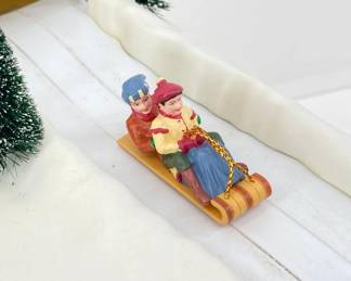 Village Animated Sledding Hill up close photo of sledders. 