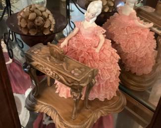 Lady in pink feathered dress playing piano